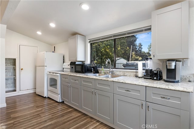 kitchen with white appliances, lofted ceiling, sink, and gray cabinetry