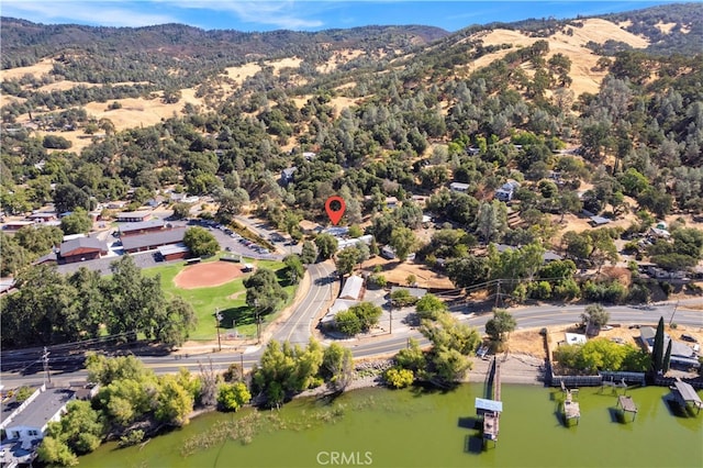 birds eye view of property featuring a water and mountain view