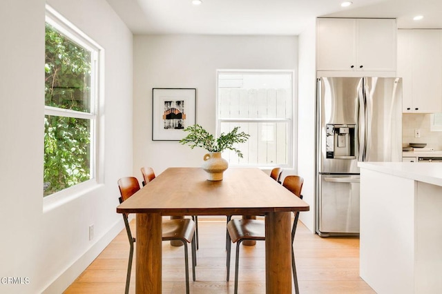 dining room with plenty of natural light and light hardwood / wood-style floors