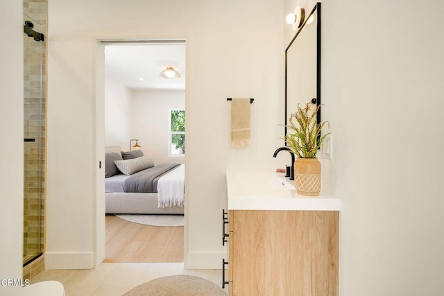 bathroom featuring hardwood / wood-style floors, vanity, toilet, and an enclosed shower