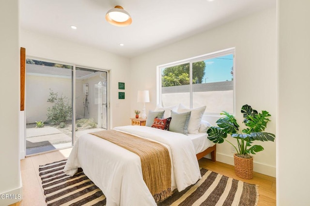 bedroom with light hardwood / wood-style floors and access to exterior