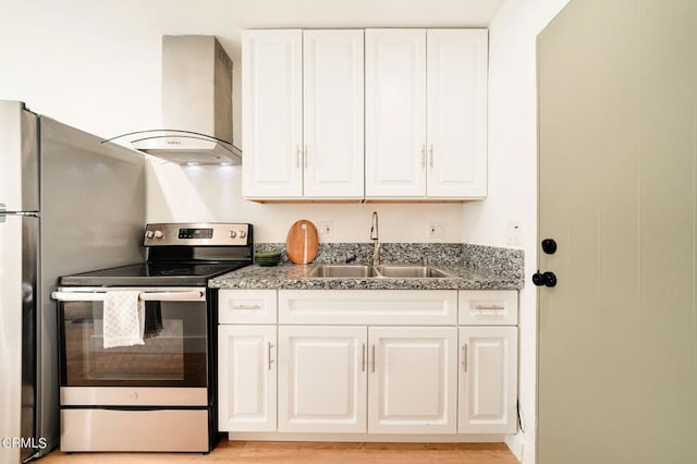 kitchen with white cabinets, sink, light hardwood / wood-style flooring, wall chimney range hood, and electric stove