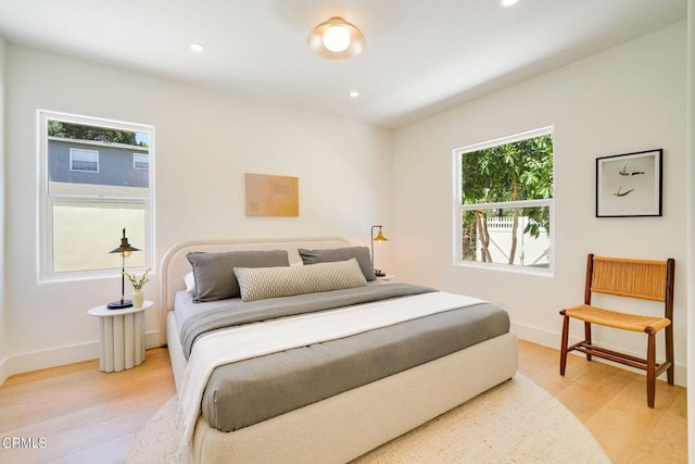 bedroom featuring light hardwood / wood-style floors and multiple windows