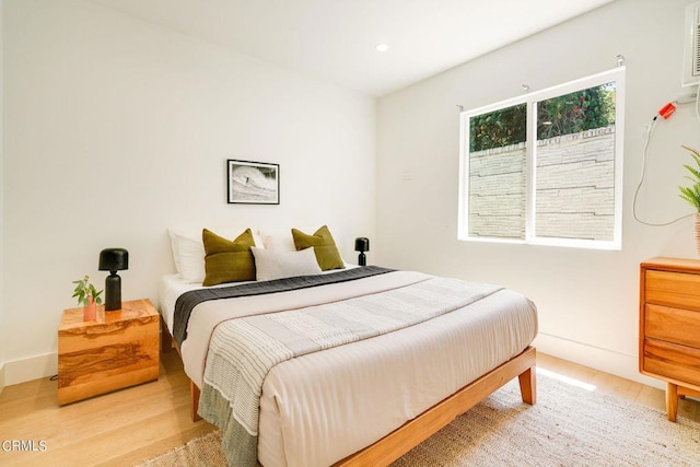 bedroom with hardwood / wood-style floors