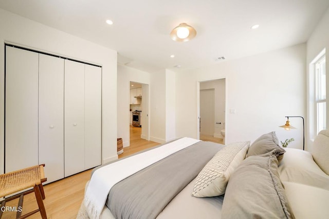 bedroom featuring light wood-type flooring and a closet