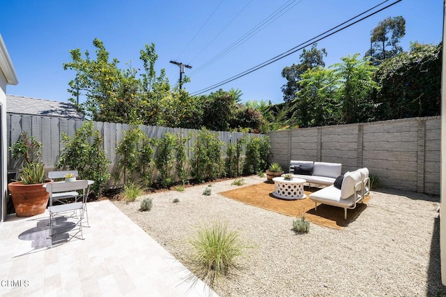 view of yard with an outdoor living space and a patio area