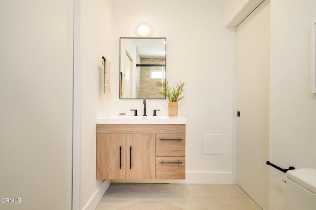 bathroom with vanity, tile patterned flooring, and toilet