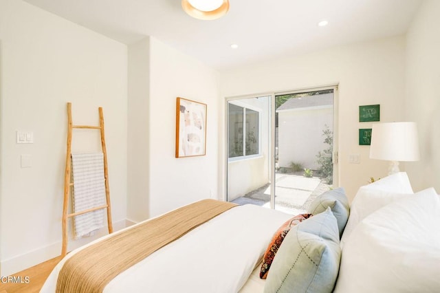 bedroom with access to outside and light wood-type flooring