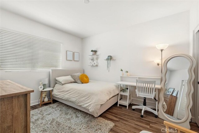 bedroom with wood-type flooring