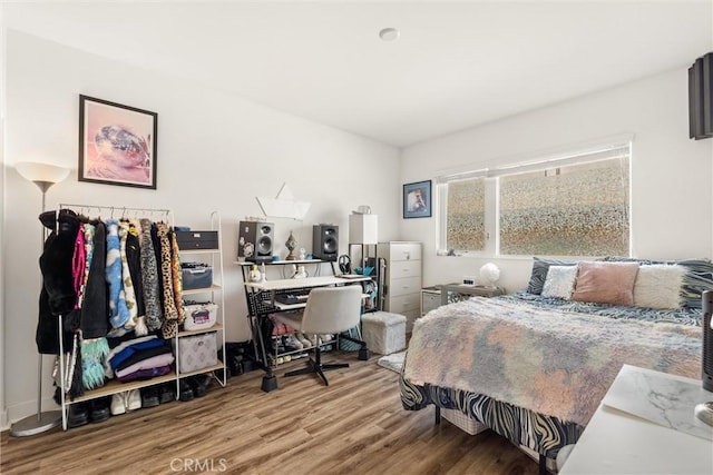 bedroom featuring wood finished floors