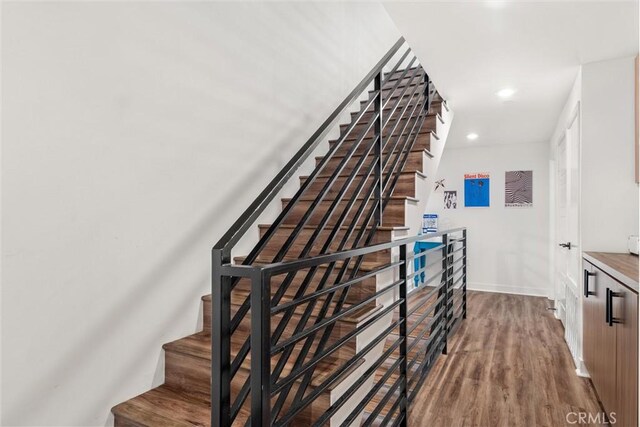 stairway featuring hardwood / wood-style floors