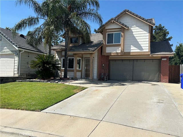 view of front of home with a front yard and a garage