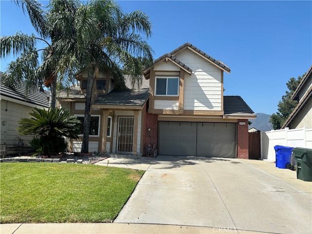 view of front of property with a front yard and a garage