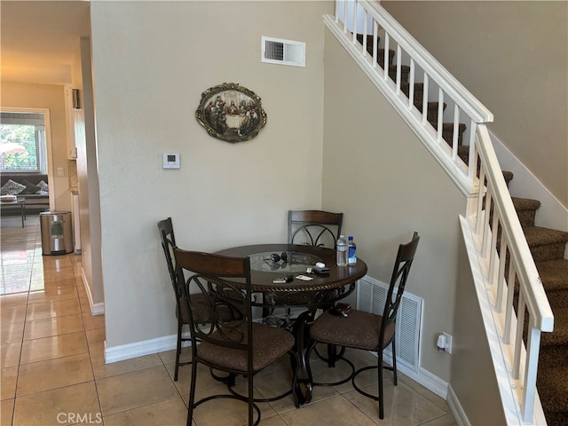 dining area featuring light tile patterned flooring