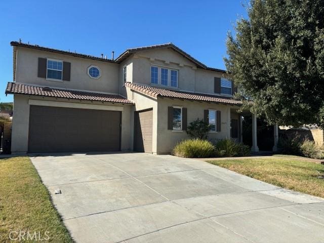 view of front of home with a garage and a front yard