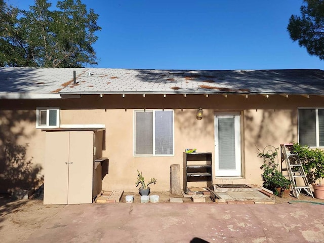 back of property with a patio