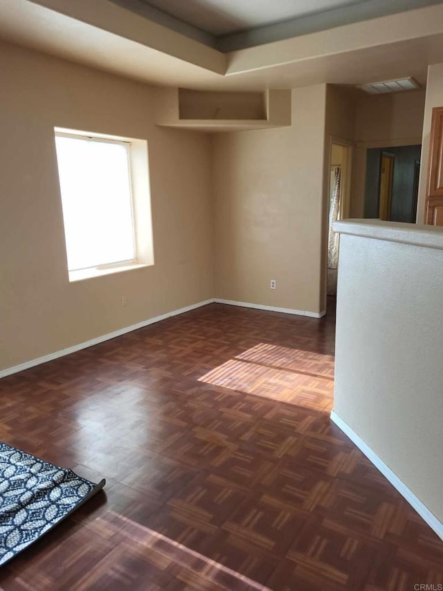 unfurnished room featuring dark parquet flooring