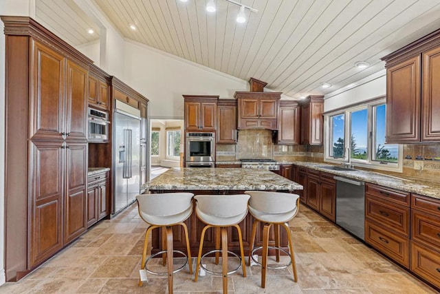 kitchen with sink, wood ceiling, stainless steel appliances, a center island, and tasteful backsplash