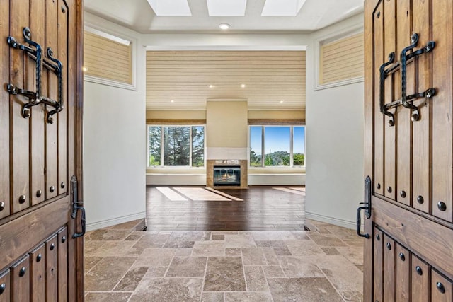 foyer entrance with plenty of natural light and a skylight