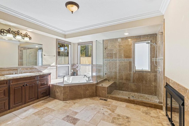 bathroom with crown molding, a healthy amount of sunlight, vanity, and plus walk in shower