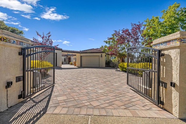 view of gate with a garage