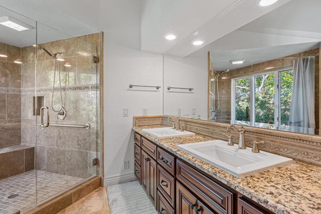 bathroom with an enclosed shower and vanity