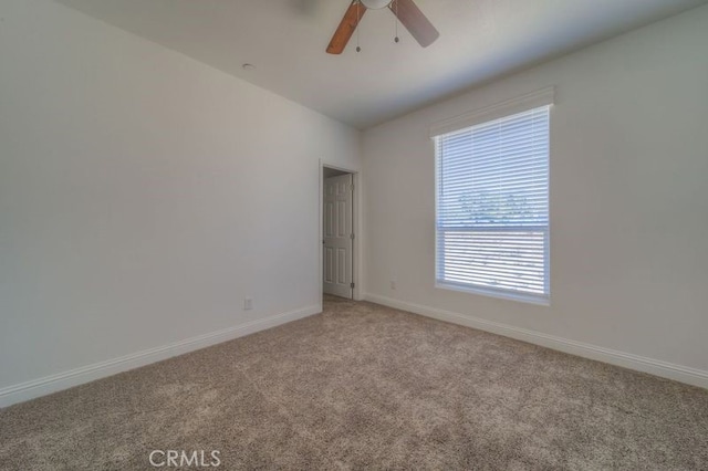 carpeted spare room with ceiling fan