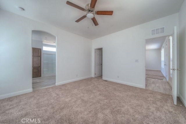 unfurnished room with ceiling fan and light carpet