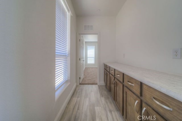 interior space with light carpet and light stone counters