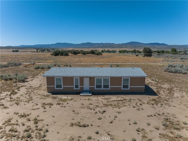 exterior space with a rural view and a mountain view