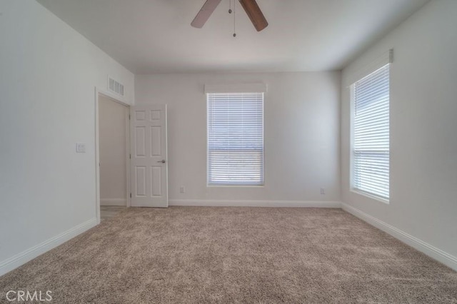 empty room featuring carpet floors and ceiling fan