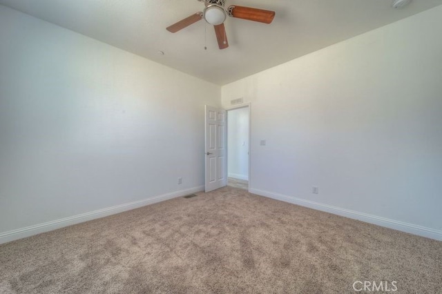 carpeted spare room with ceiling fan