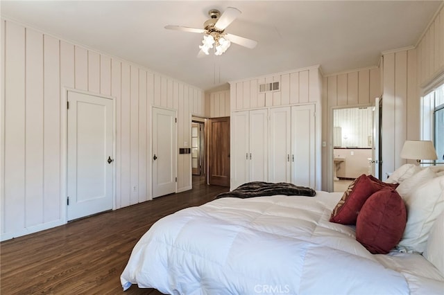 bedroom with ceiling fan, dark hardwood / wood-style flooring, and ensuite bathroom