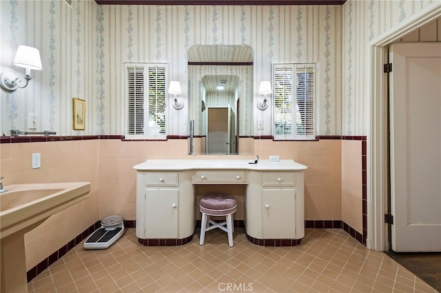 bathroom with tile walls and tile patterned flooring