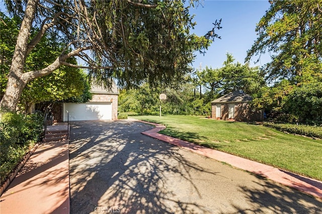 view of yard featuring a garage and an outdoor structure