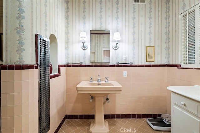 bathroom with tile patterned flooring and tile walls