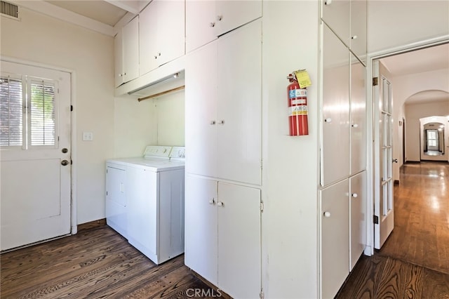 clothes washing area featuring washing machine and dryer, cabinets, and dark wood-type flooring