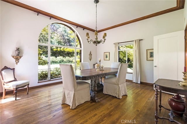 dining space featuring an inviting chandelier, ornamental molding, and dark hardwood / wood-style floors