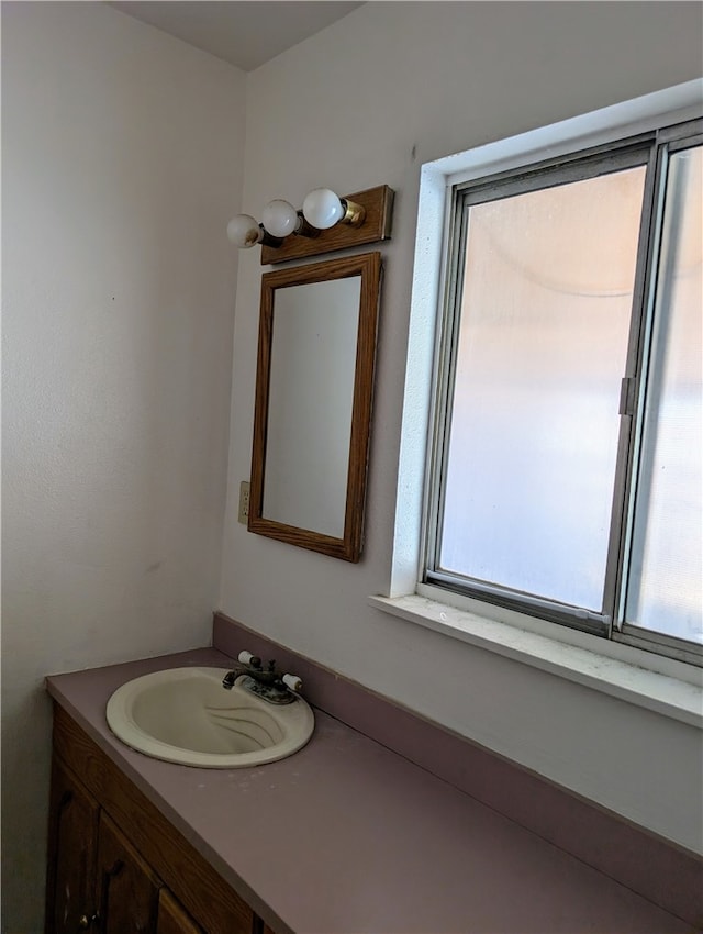 bathroom with vanity and plenty of natural light