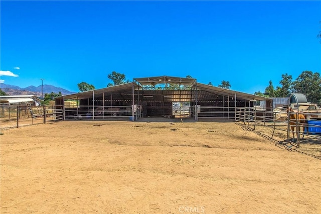 view of horse barn featuring a mountain view