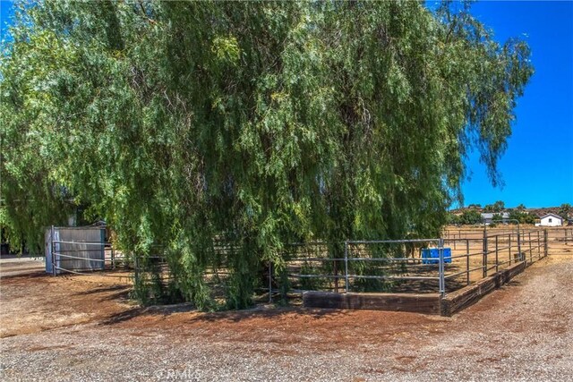 view of horse barn with a rural view