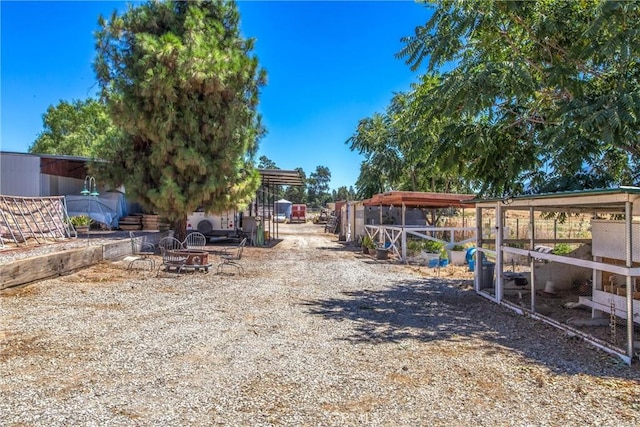 view of yard with a fire pit and an outdoor structure