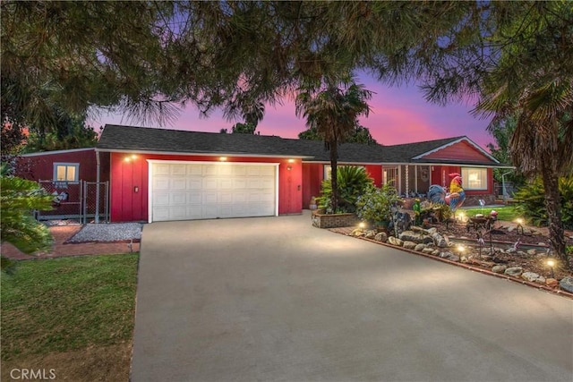 single story home featuring concrete driveway and an attached garage