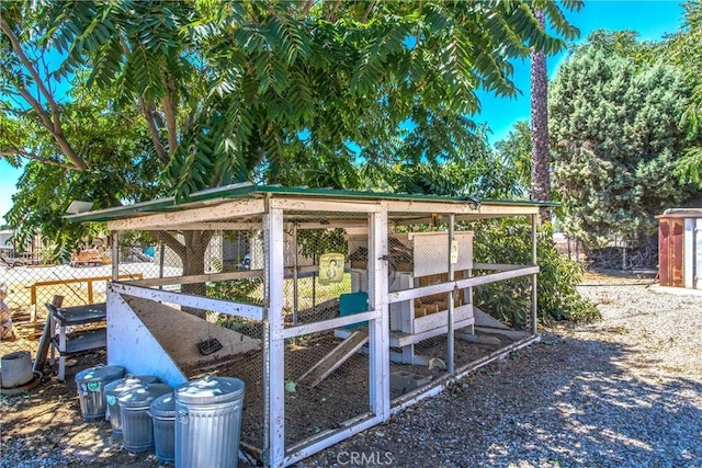 view of poultry coop featuring fence