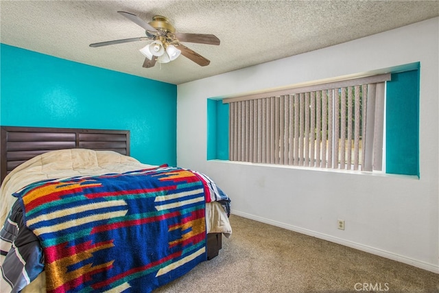 bedroom with ceiling fan, a textured ceiling, and carpet floors