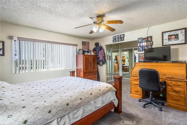 bedroom featuring ceiling fan, carpet, and a textured ceiling