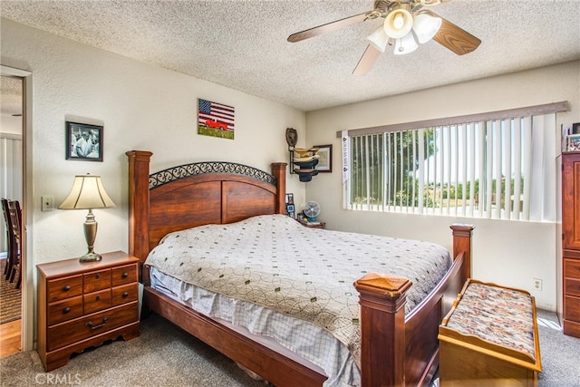 bedroom featuring a textured ceiling, carpet floors, and ceiling fan