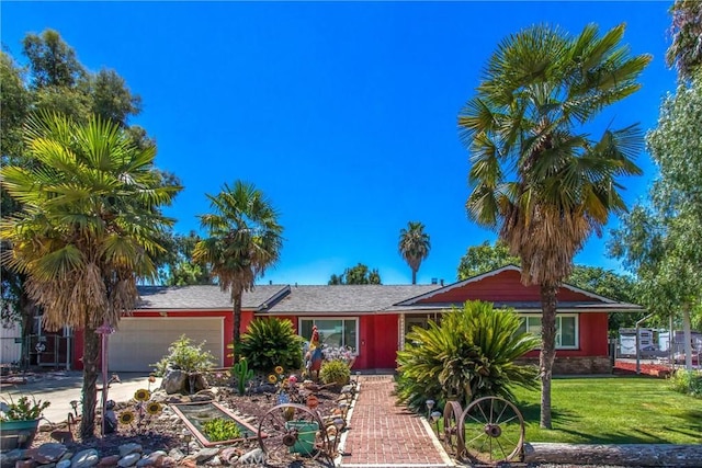 ranch-style house featuring an attached garage, a front lawn, and concrete driveway