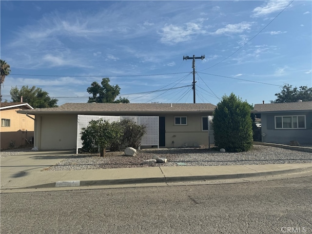 ranch-style house featuring a carport