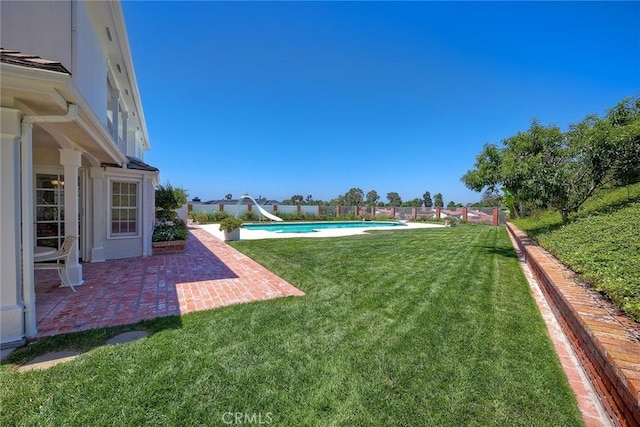 view of yard featuring a patio and a fenced in pool